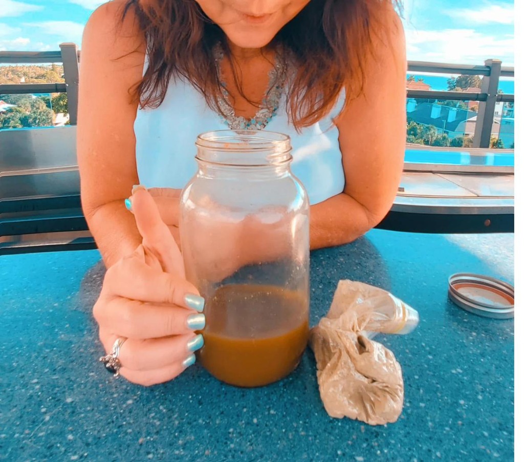 Founder holding her mason jar of EcoFit — the green drink that started it all